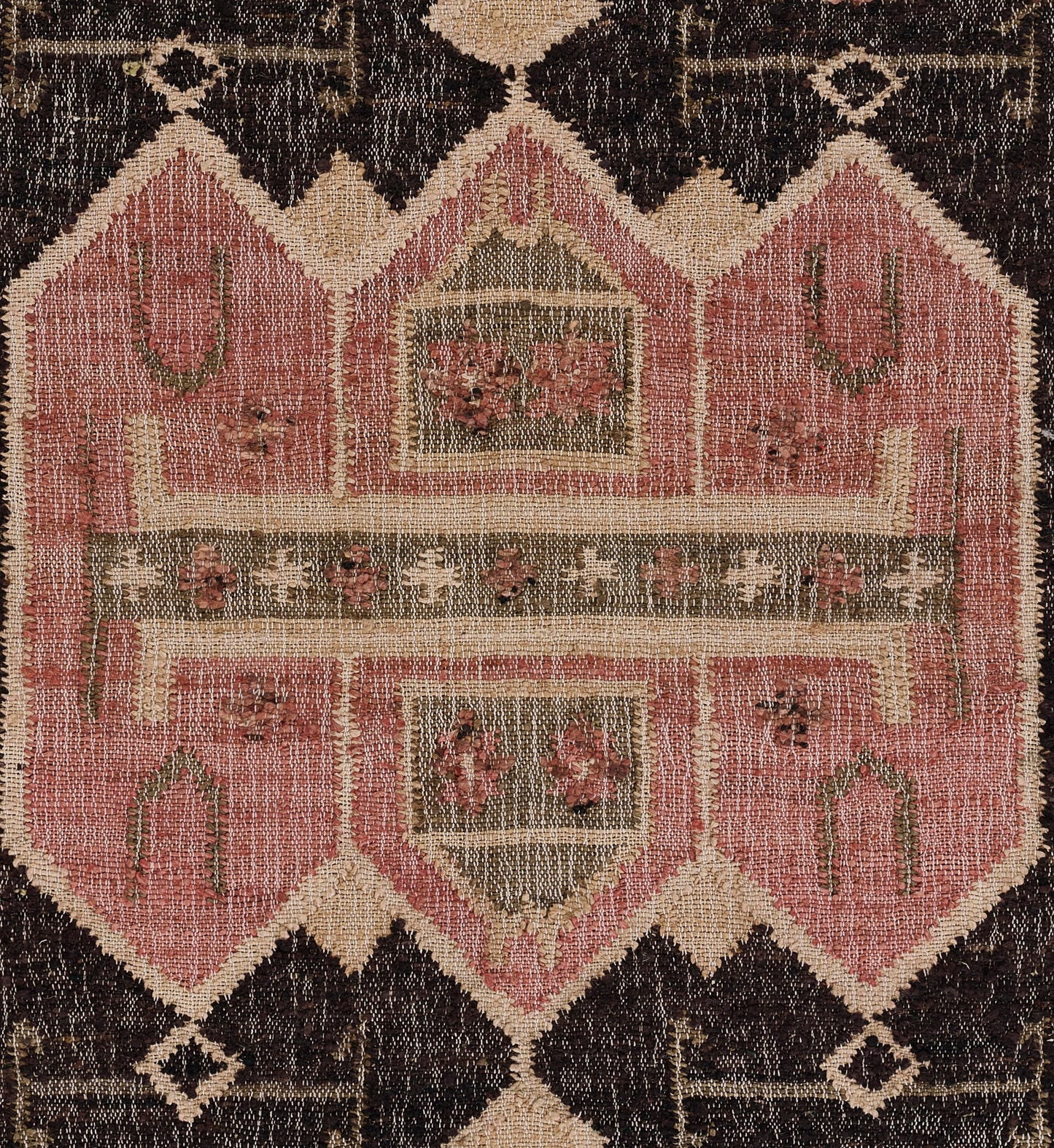 Pink and beige geometric rug with floral accents, olive highlights and a dark brown border in vintage oriental style.