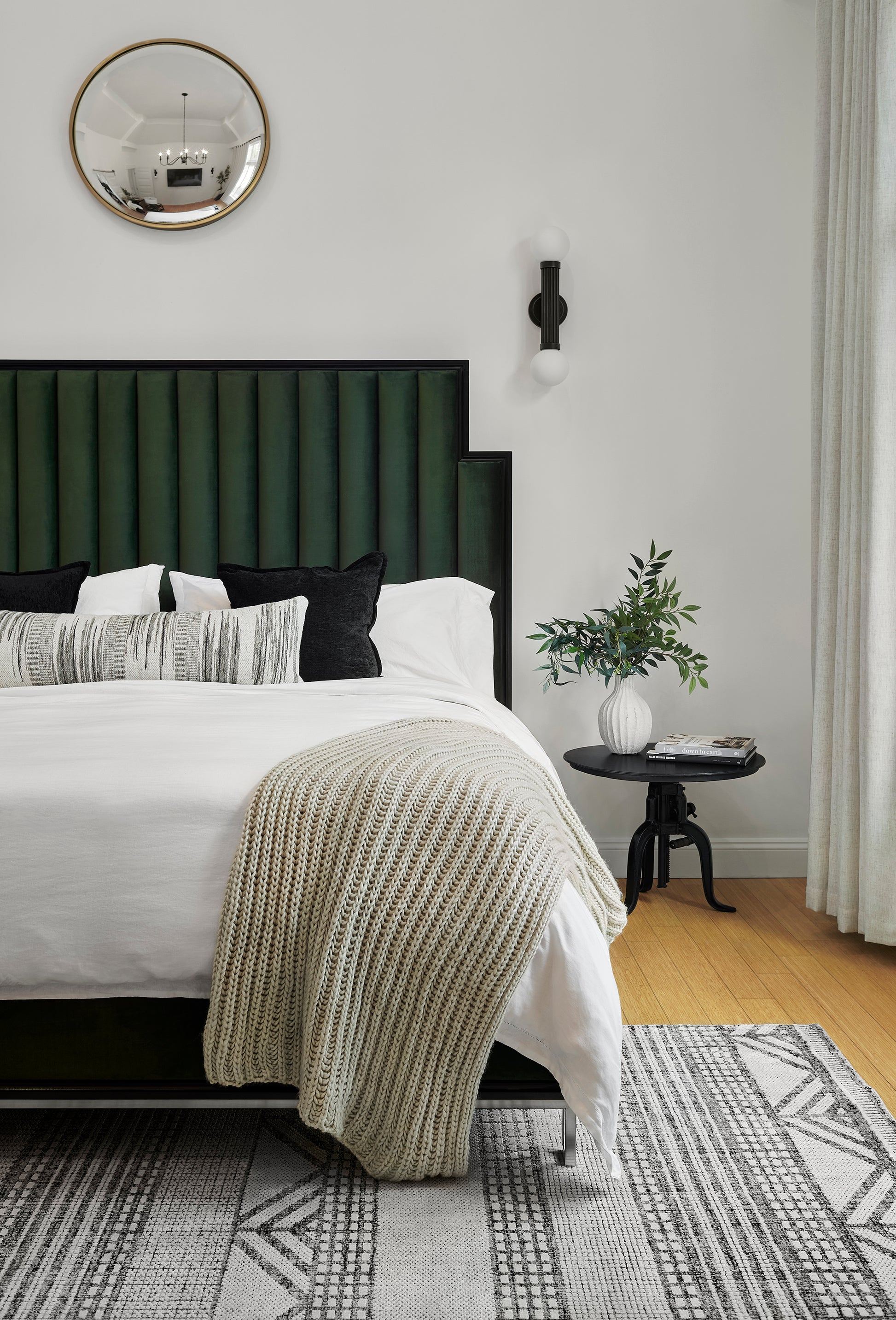 Green rug on floor with plant accents and neutral décor