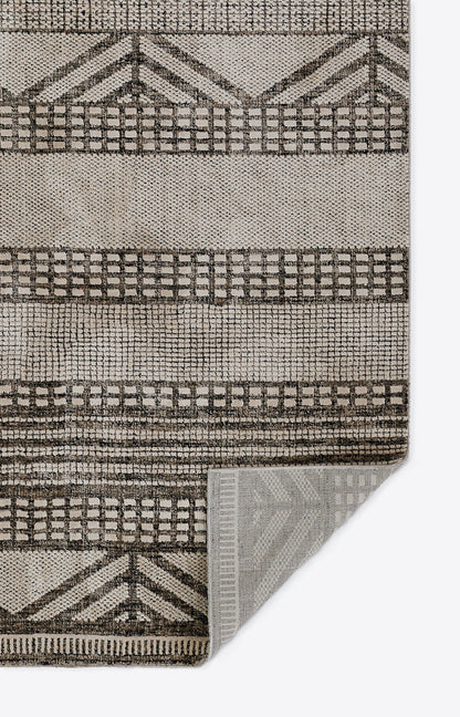 Neutral beige and tan geometric area rug with grid and chevron motifs; woven texture, rectangular for living room decor.