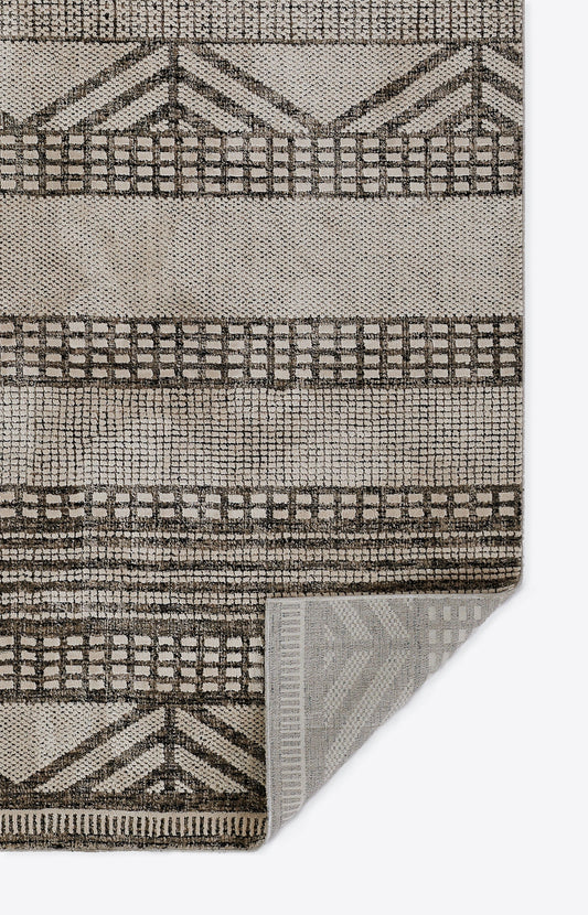 Neutral beige and tan geometric area rug with grid and chevron motifs; woven texture, rectangular for living room decor.
