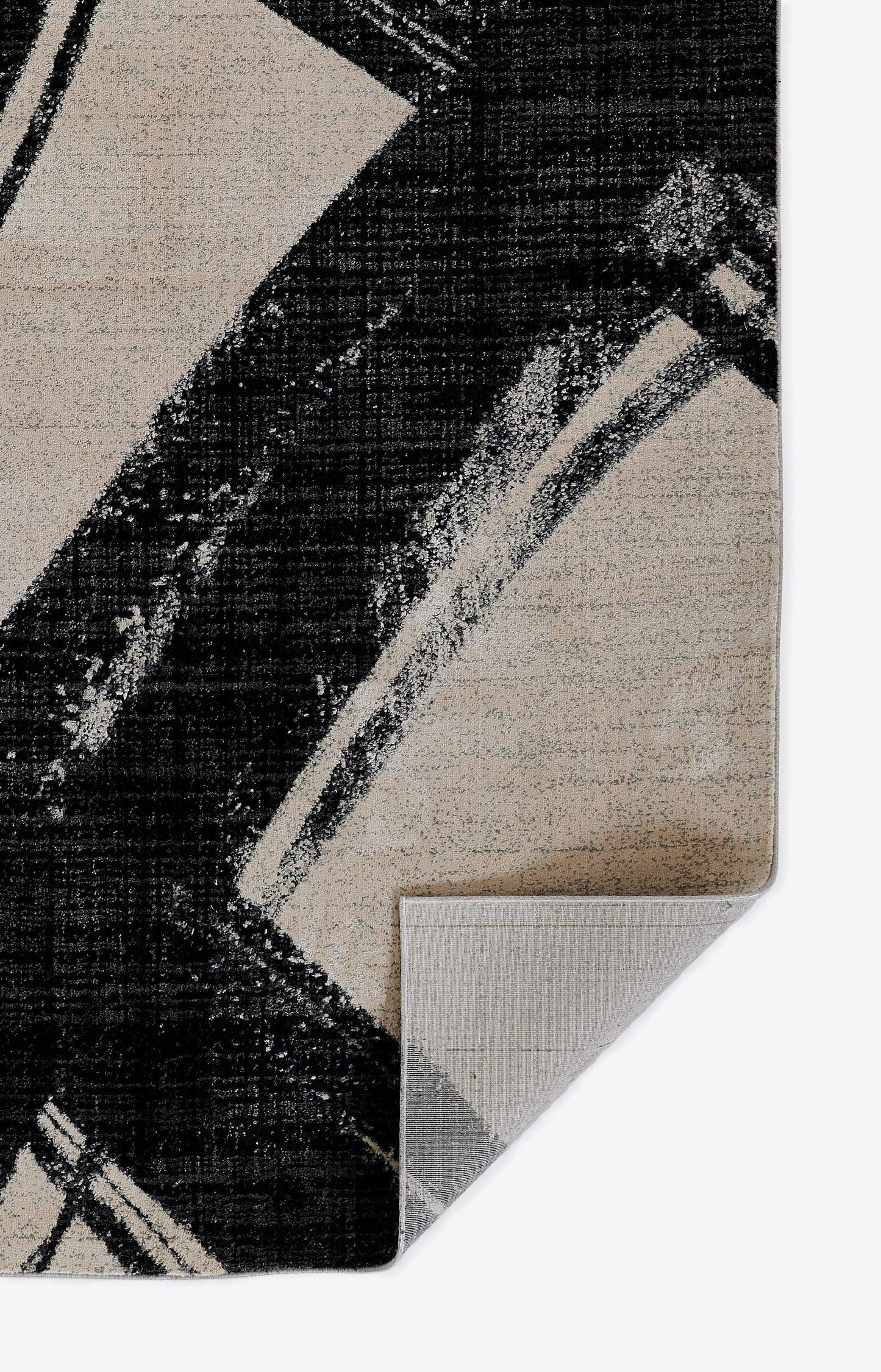 Abstract geometric area rug in black, beige and gray with distressed lines; rectangular plush pile, 8' x 10'.