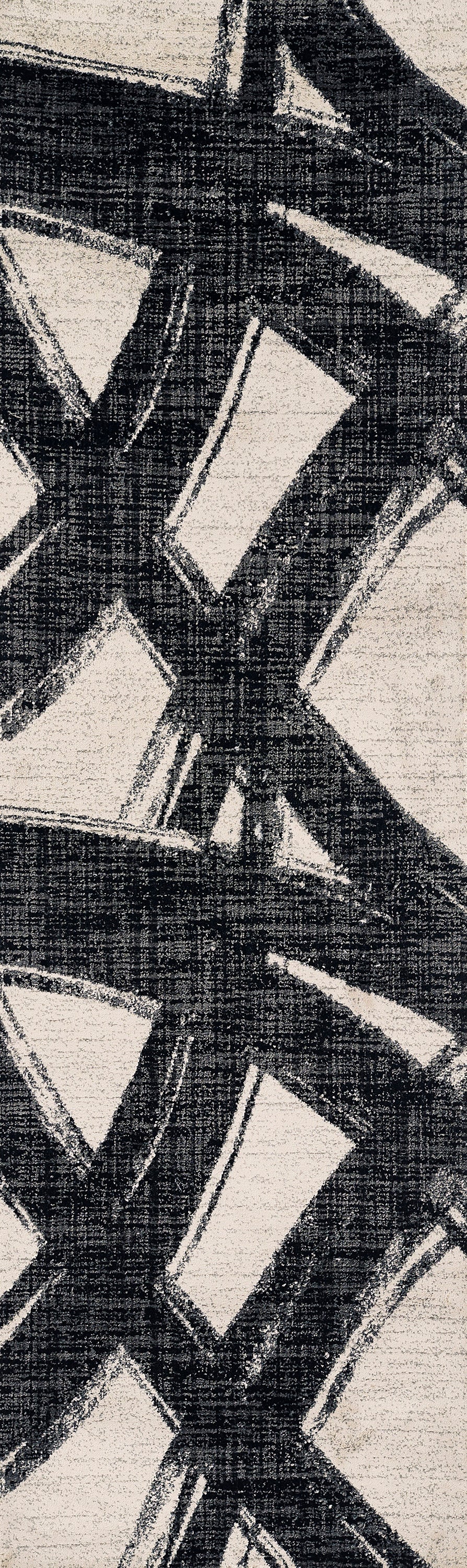Geometric black and ivory woven rug with bold diamond shapes and textured surface.