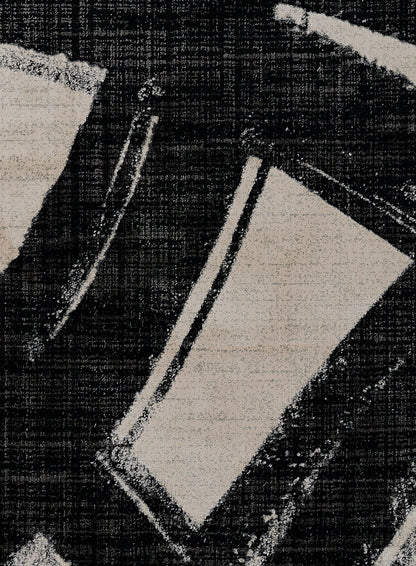 Black denim with beige abstract geometric print—curved stripe and rectangular shapes in a textured weave.
