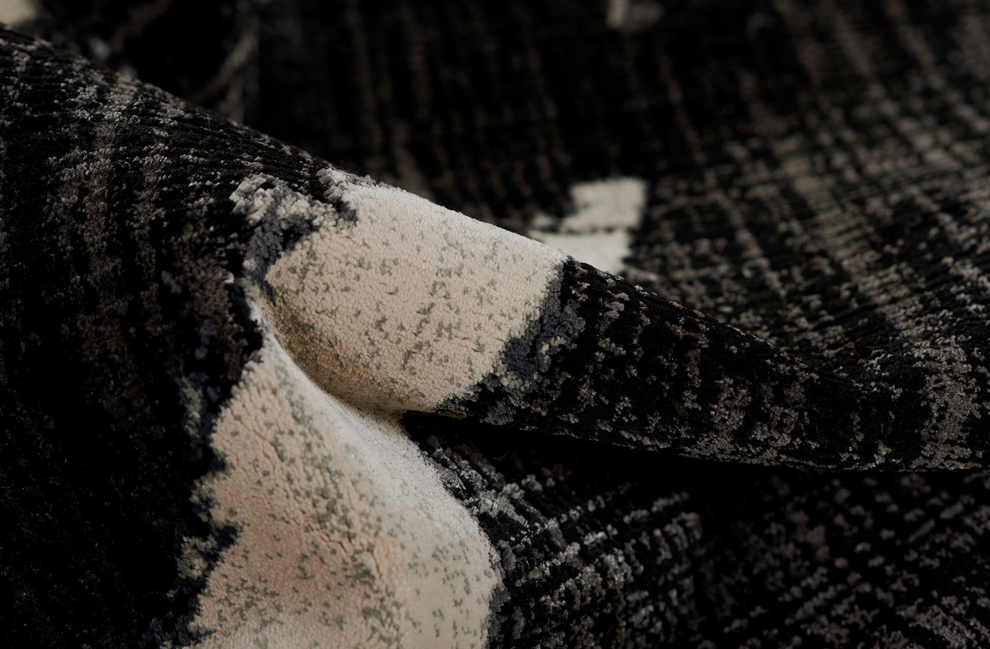 Ivory & black boucle textile with speckled plush texture, soft rug.