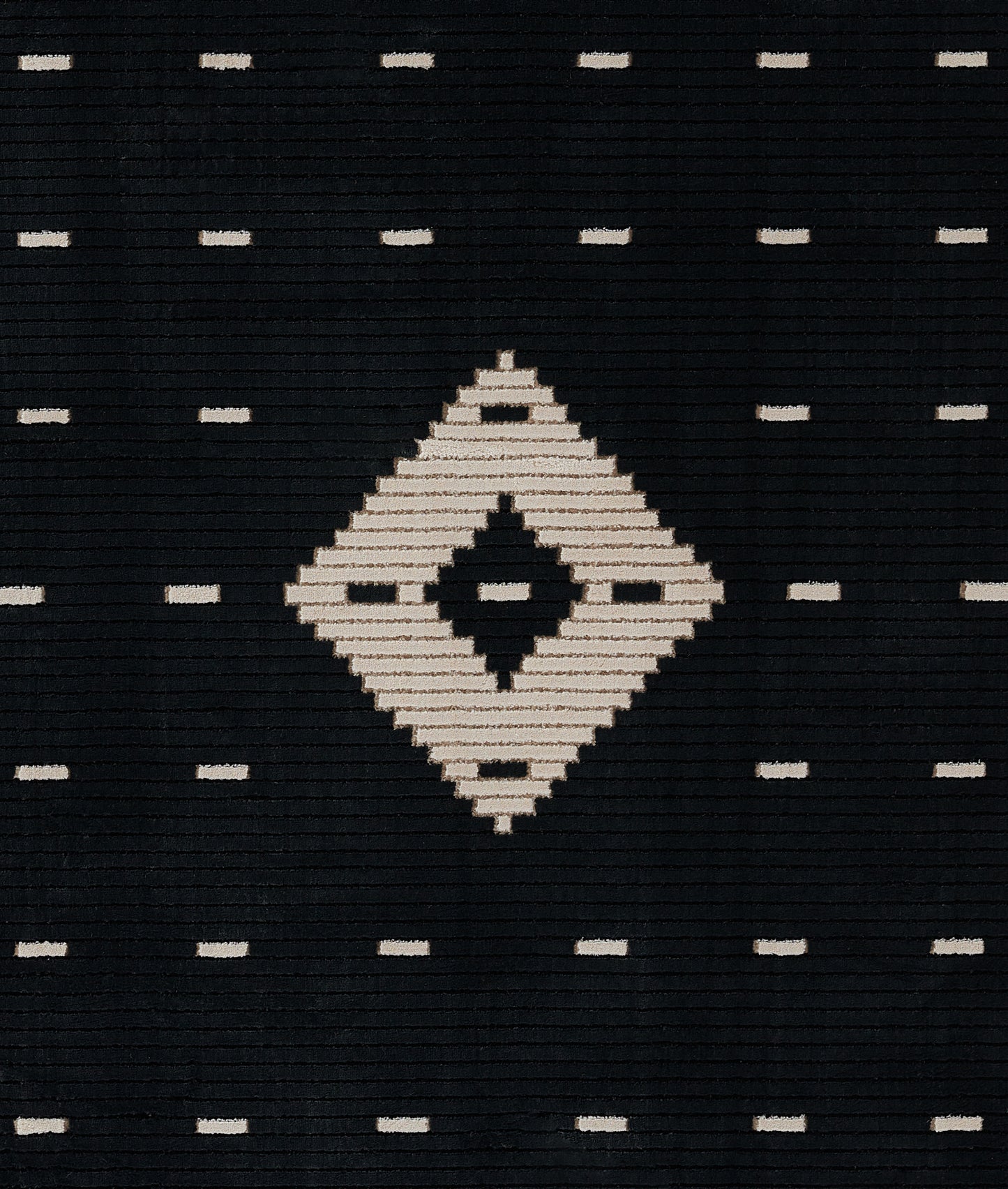 Dark navy woven rug featuring a large ivory diamond center and tiny ivory dash motifs; geometric tribal-inspired textile.