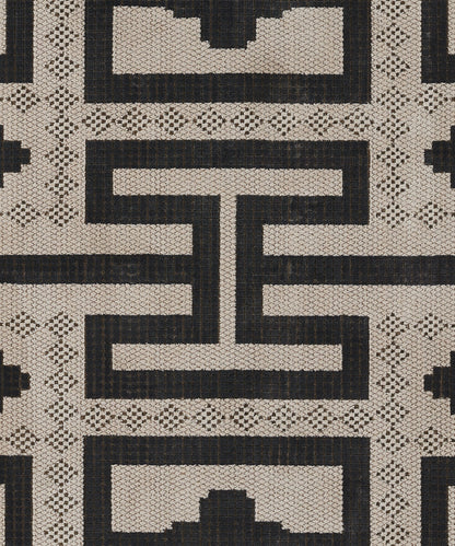 Ivory and black woven geometric rug with Greek key motif and lattice texture.