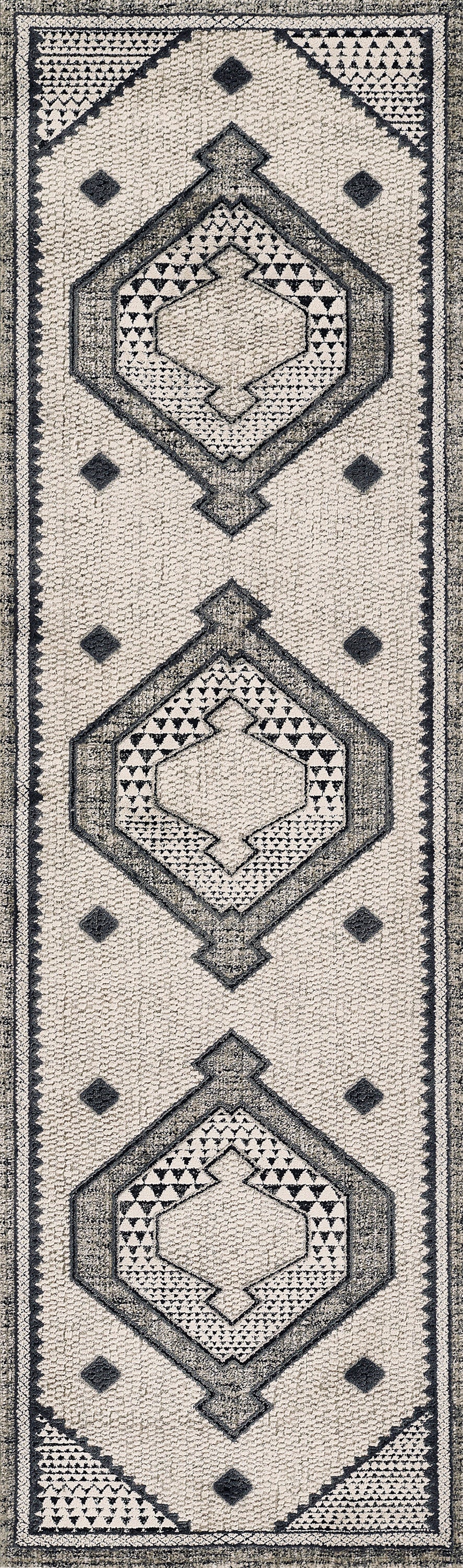Beige textured rug with repeating dark gray geometric diamond medallions and triangle borders.
