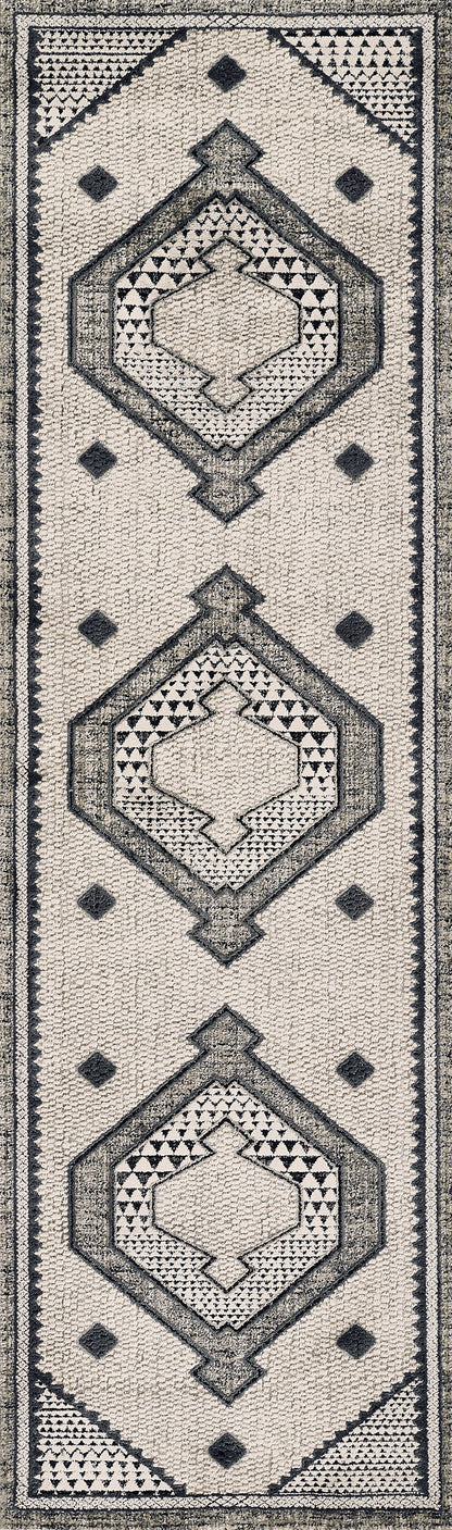 Beige textured rug with repeating dark gray geometric diamond medallions and triangle borders.
