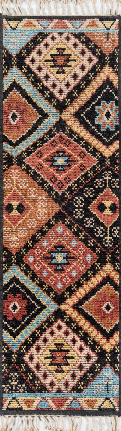 Kilim rug with bold diamond motifs in black, red, tan, blue and ivory; fringed ends.