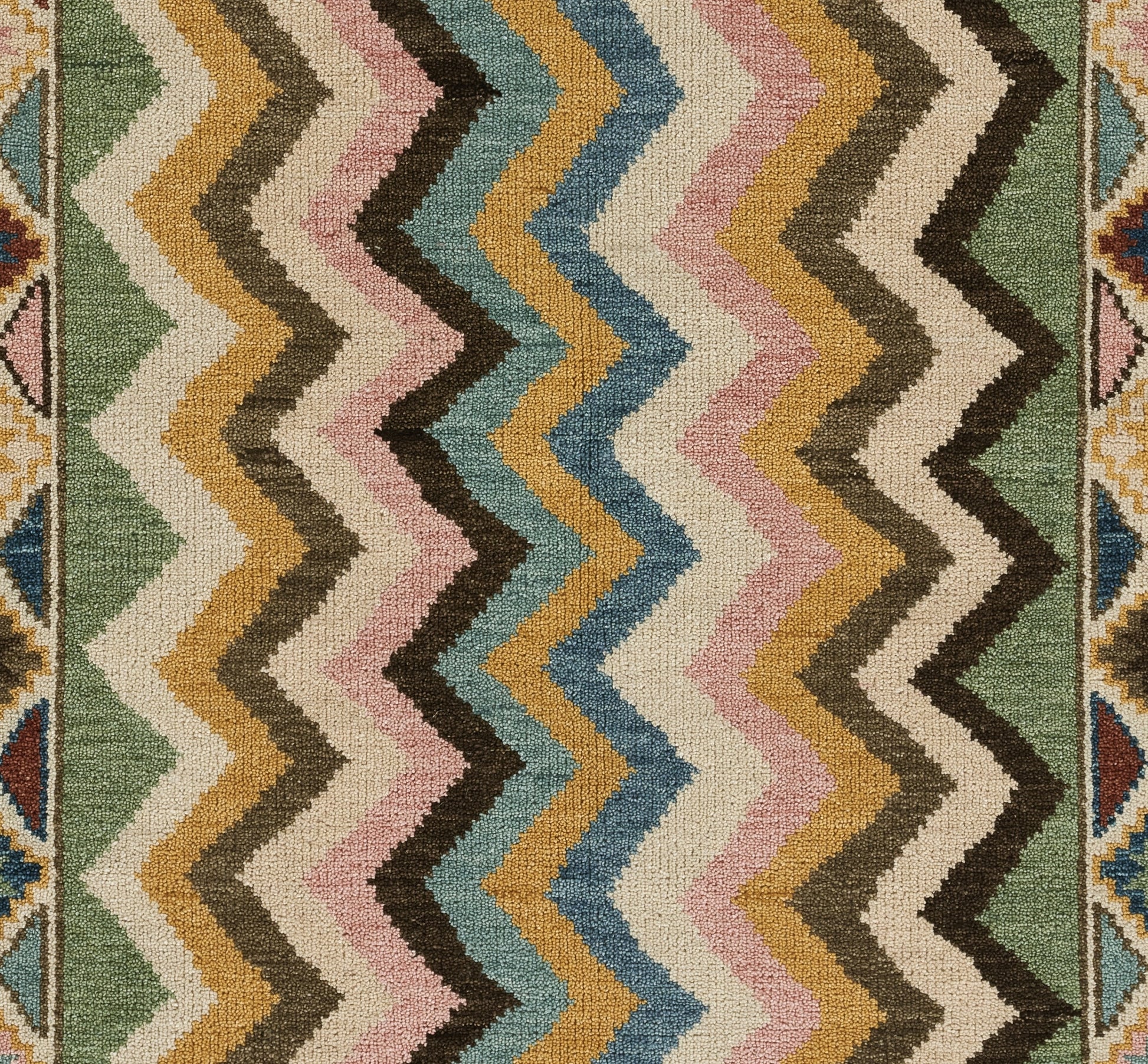 Beige rectangular rug with a narrow multicolor striped kilim border along the top edge.