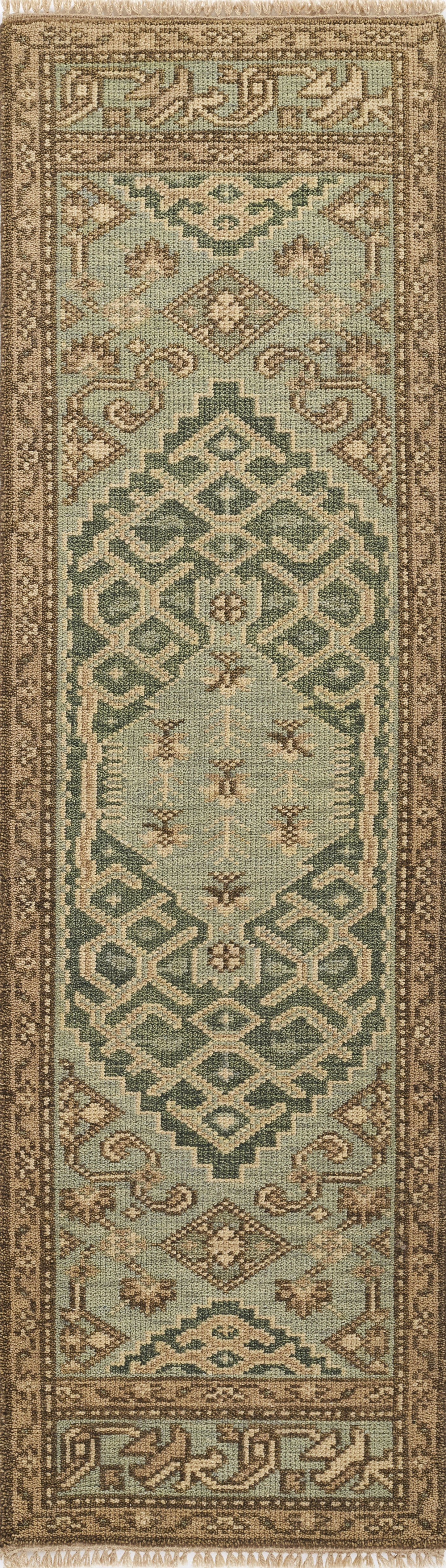 NOMADNOM-8LBL area rug in teal and beige with brown geometric medallions, fringed ends, tribal-inspired.