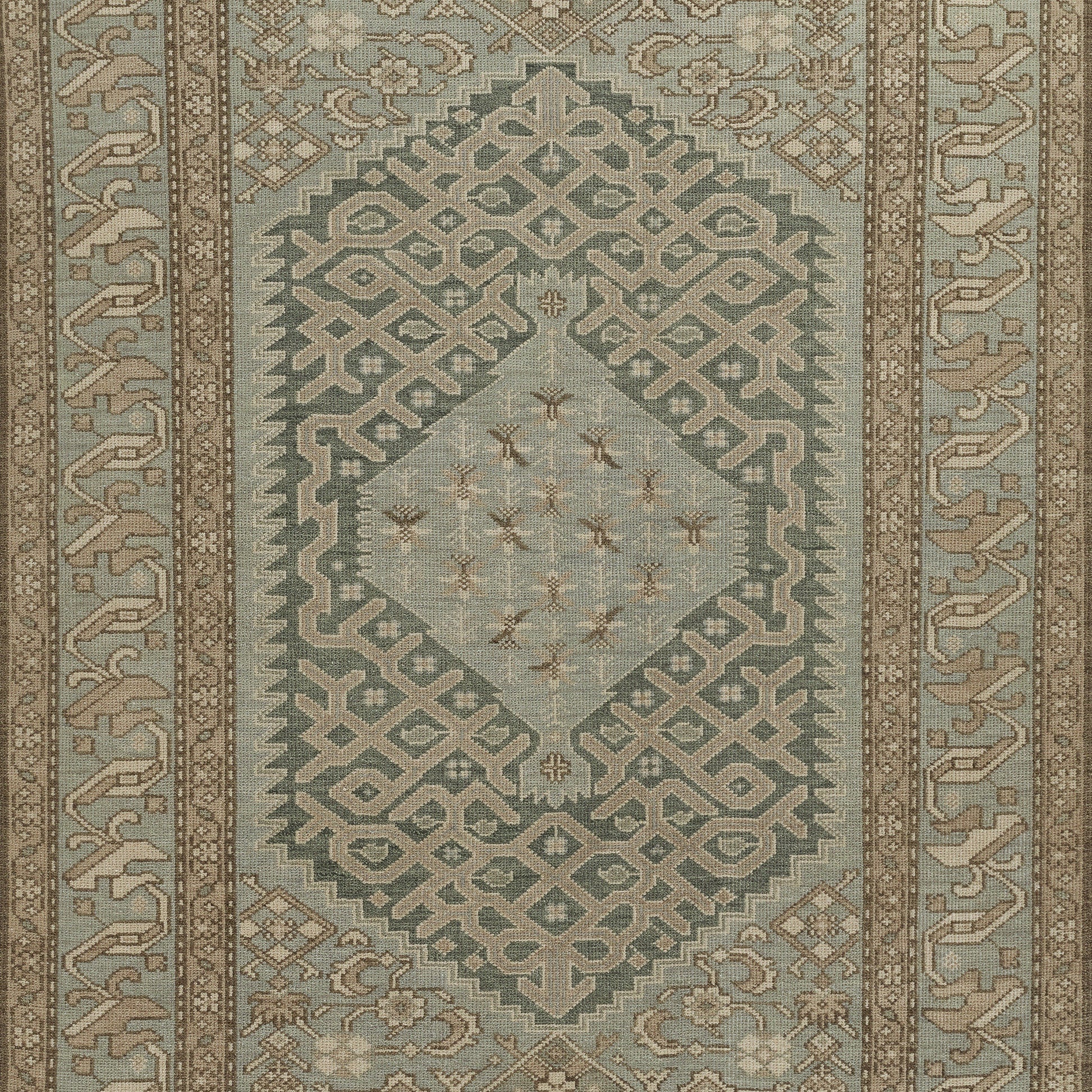 Nomad-inspired kilim rug with teal-blue, beige & ivory tones, central diamond medallion, geometric lattice borders; area rug.