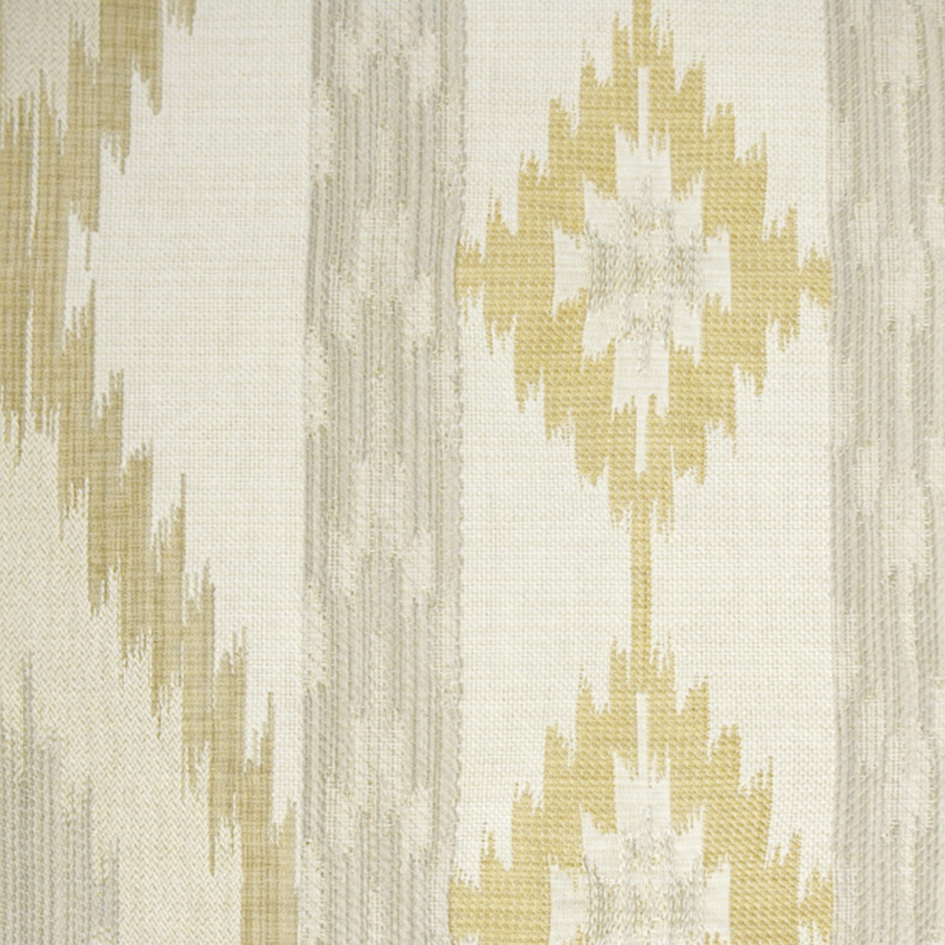 Ivory and gold ikat fabric with large diamond motifs and woven texture.