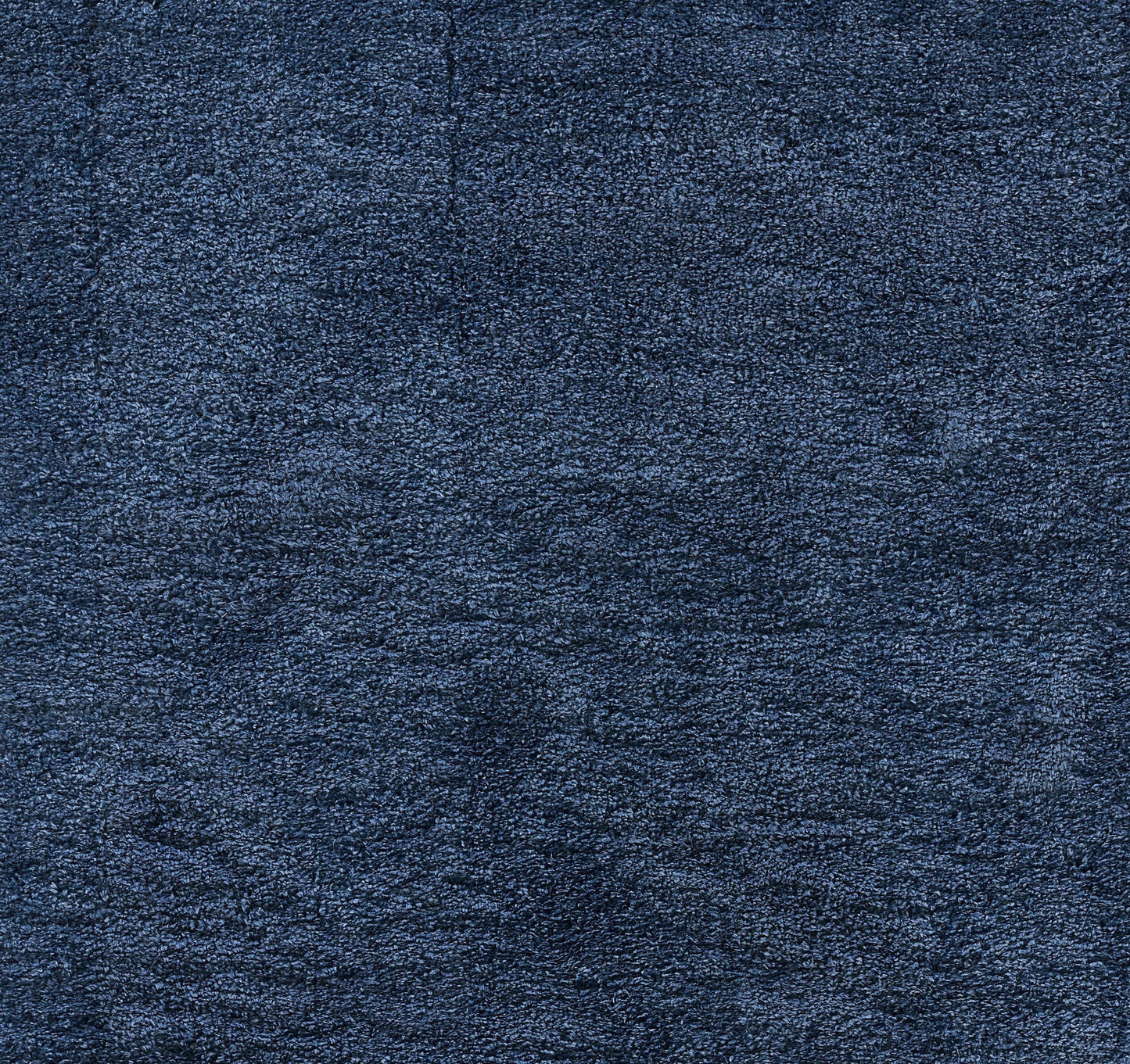 Dark navy blue shag rug close-up showing thick, fluffy fibers.