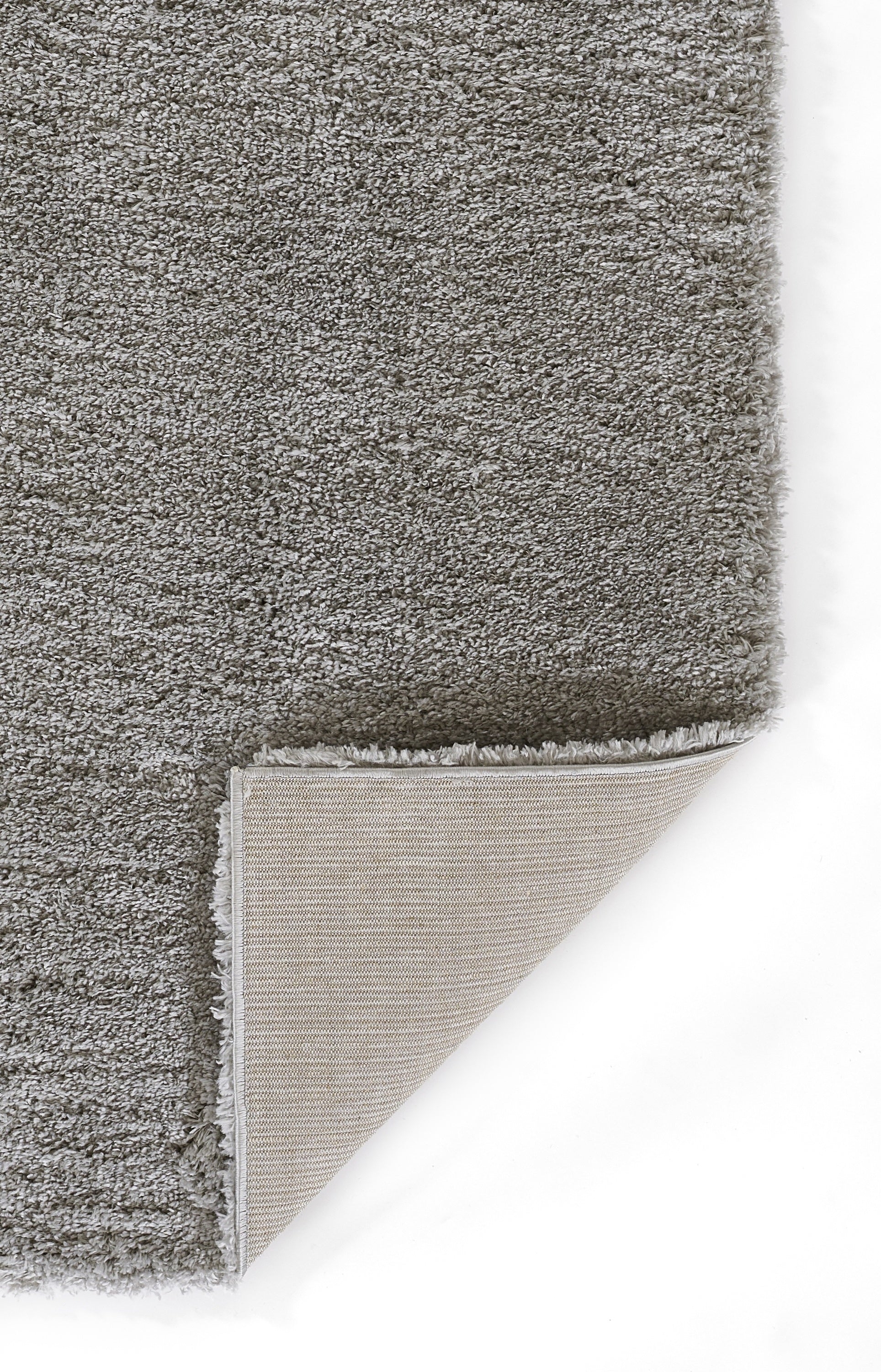 Grey shag rug with plush high-pile texture and beige fabric backing; corner folded.