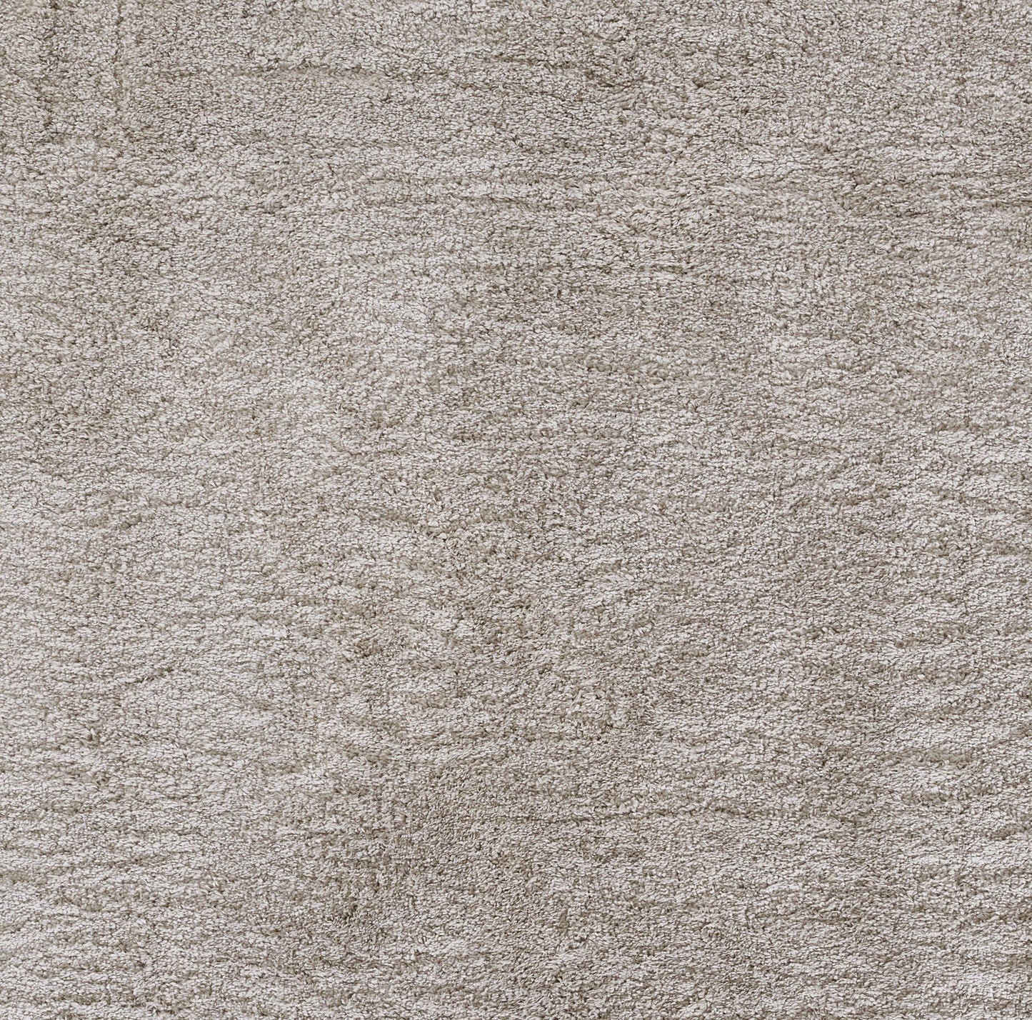 Beige textured shag rug with dense soft pile; close-up view.