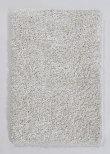 Cream plush shag rug, rectangular fluffy faux-fur texture for cozy bathroom or bedroom decor.