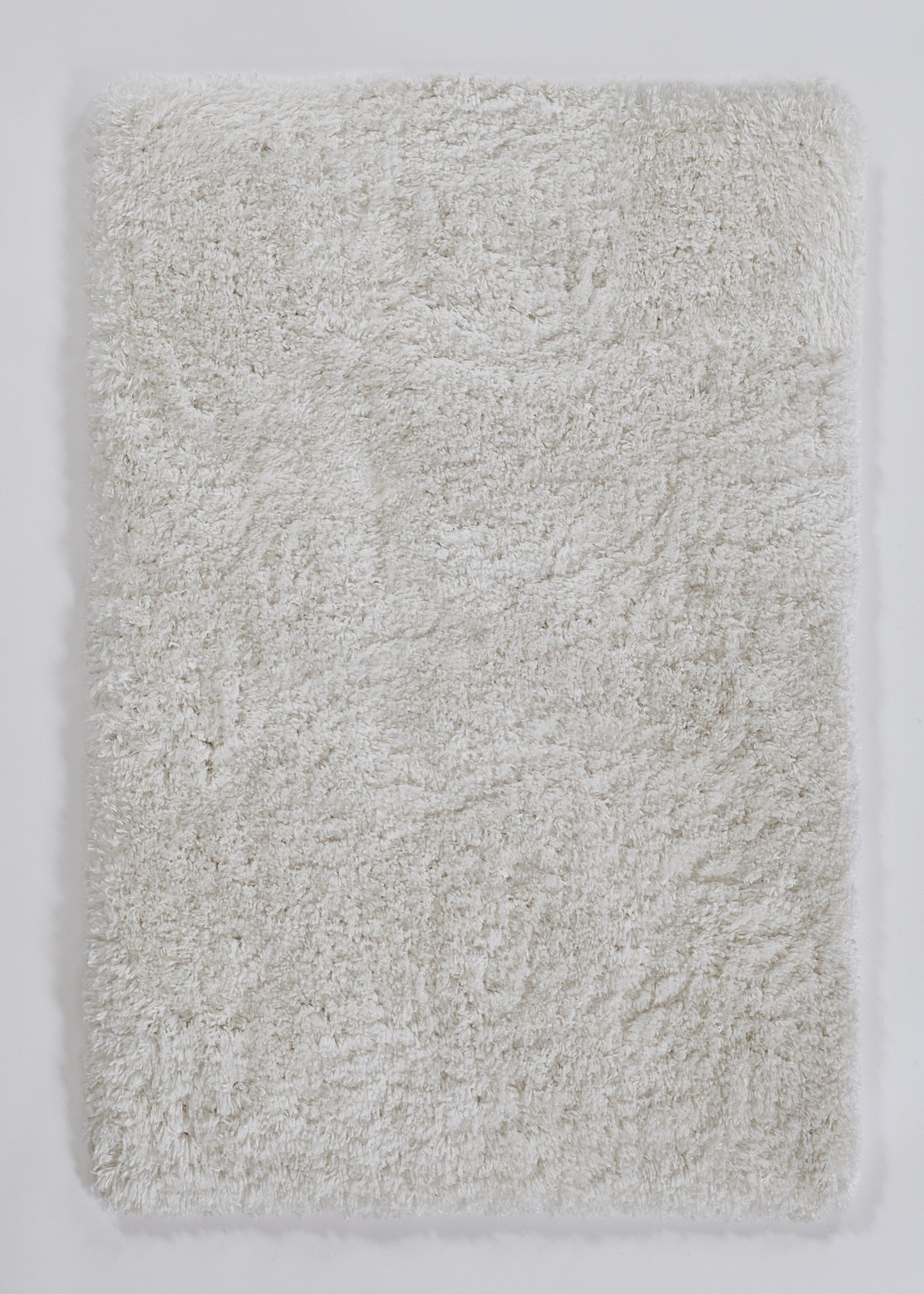 Cream shaggy bath rug with long plush pile; rectangular microfiber mat for bathroom.