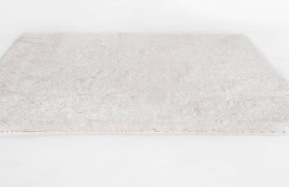 Cream shag rug with fluffy high-pile texture, rectangular plush carpet for living room.