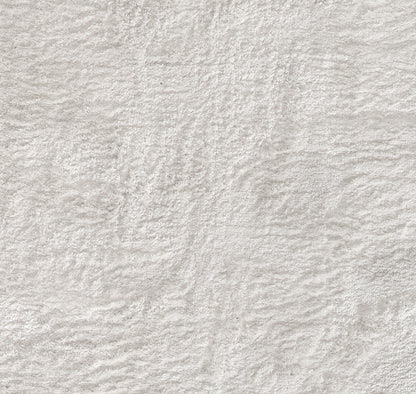 Soft beige-gray textured fabric surface with plush, irregular pile for cozy interior decor.