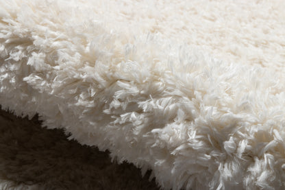 White shag rug with long fluffy pile, plush texture for a cozy, modern living room.