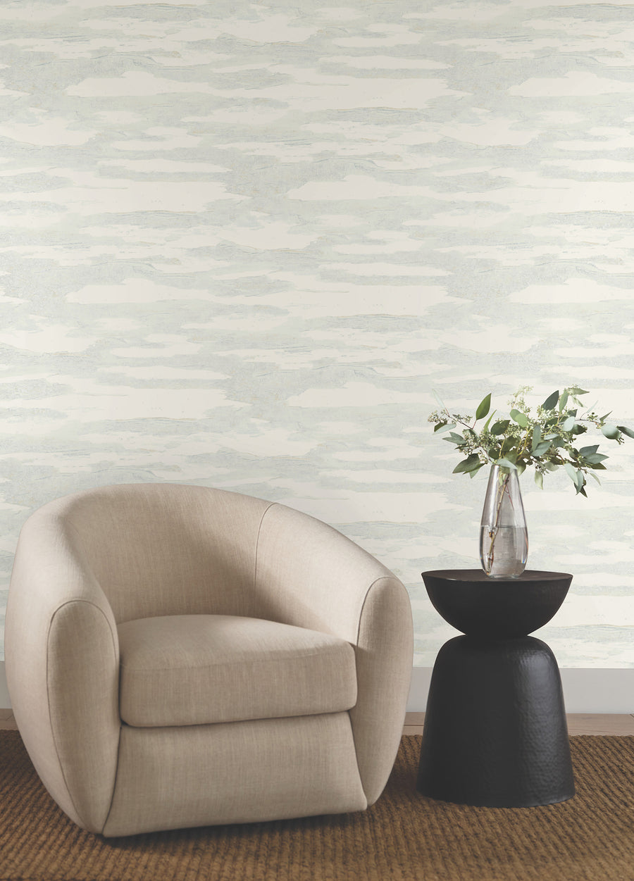 Spa blue and beige abstract wallpaper with flowing wave-like patterns, soft layered textures, and shimmering glass-bead accents for a serene modern coastal interior.
