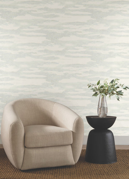 Spa blue and beige abstract wallpaper with flowing wave-like patterns, soft layered textures, and shimmering glass-bead accents for a serene modern coastal interior.