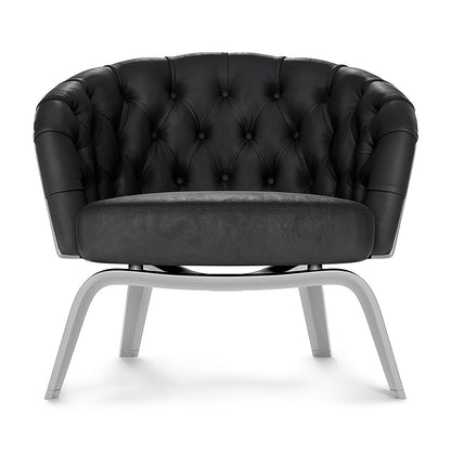 Black solid fabric barrel chair with rounded, tufted back and silver curved metal legs.