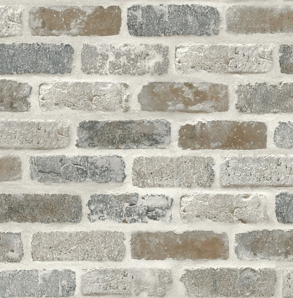 Realistic faux brick peel and stick wallcovering in gray and rust tones, Washed Brick design by NextWall, exposed brick look wallpaper for industrial accent walls, removable and washable wallcovering for modern loft-style interiors