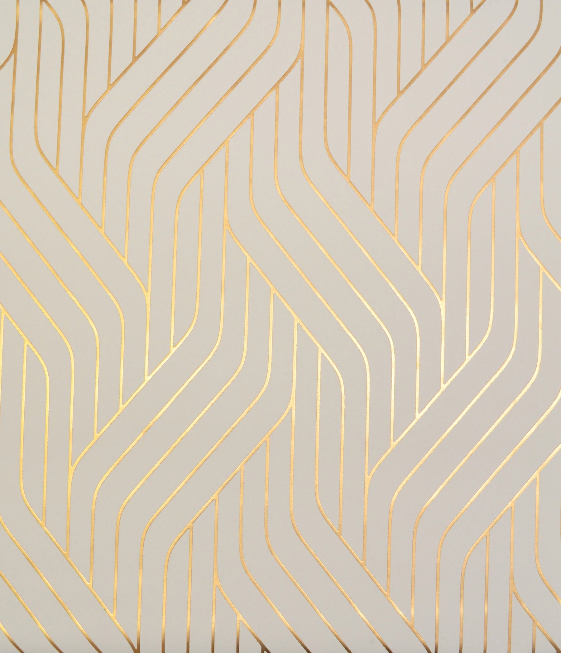 Gold metallic interlocking chevron lines on pale beige wallpaper.