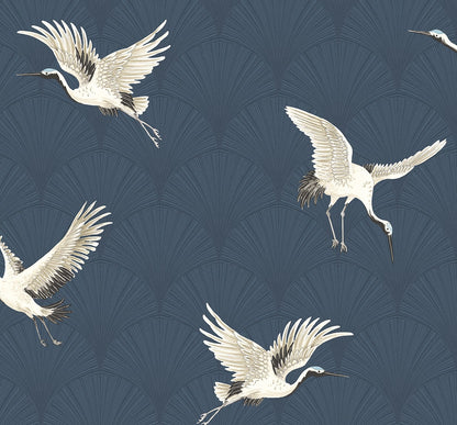 White cranes in flight against a dark blue wallpaper with pale, radiating fan patterns.