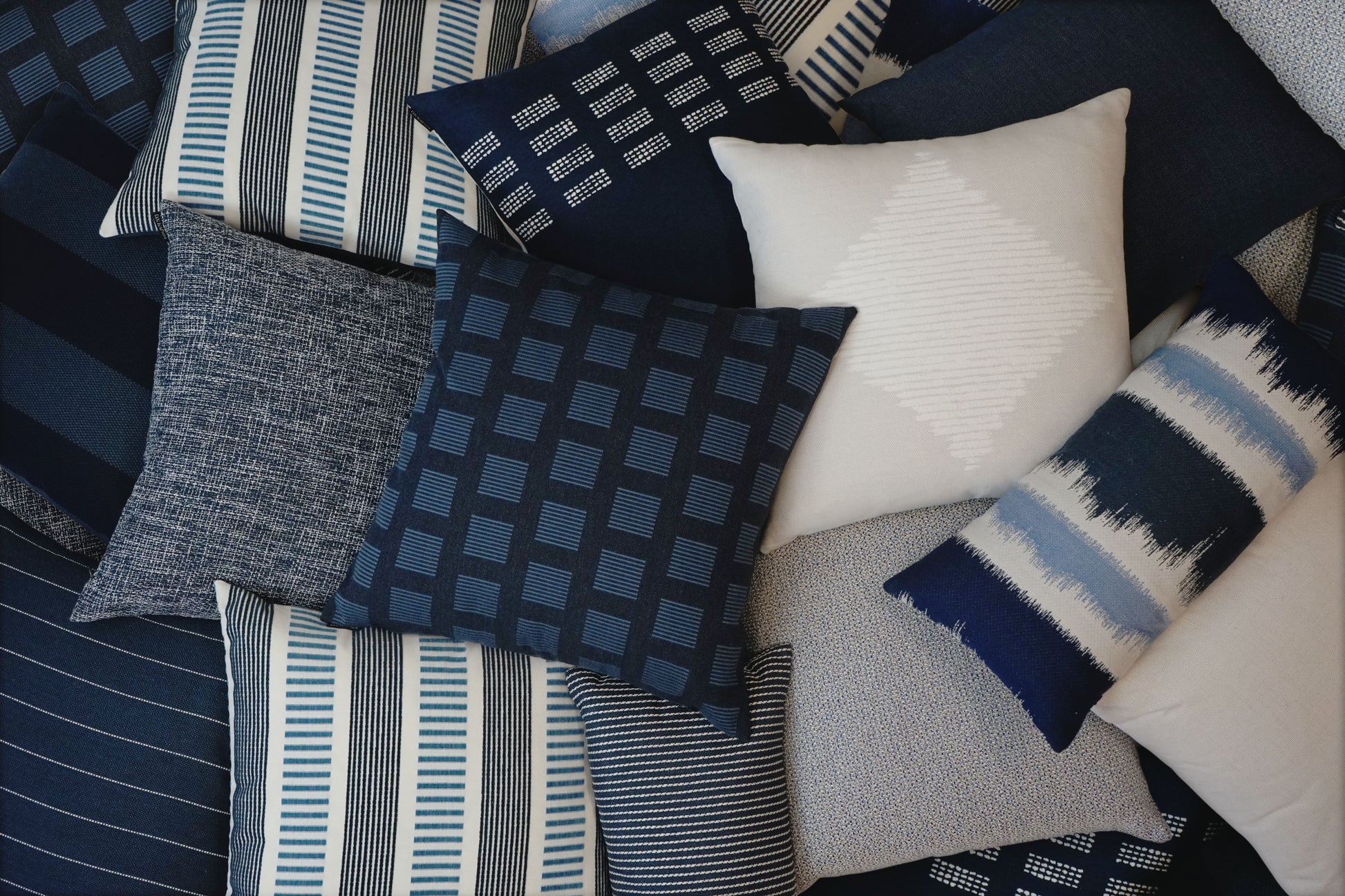 22-inch D.V. KAP HOME Malibu Indigo outdoor pillow featuring classic blue and ivory striped fabric with coastal nautical design. Luxury square accent pillow with Deluxe Angel Hair insert styled for outdoor patios, poolside seating, beach house decor, modern porches, and coastal living room interiors.