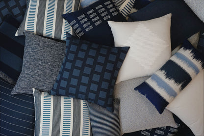 22-inch D.V. KAP HOME Malibu Indigo outdoor pillow featuring classic blue and ivory striped fabric with coastal nautical design. Luxury square accent pillow with Deluxe Angel Hair insert styled for outdoor patios, poolside seating, beach house decor, modern porches, and coastal living room interiors.