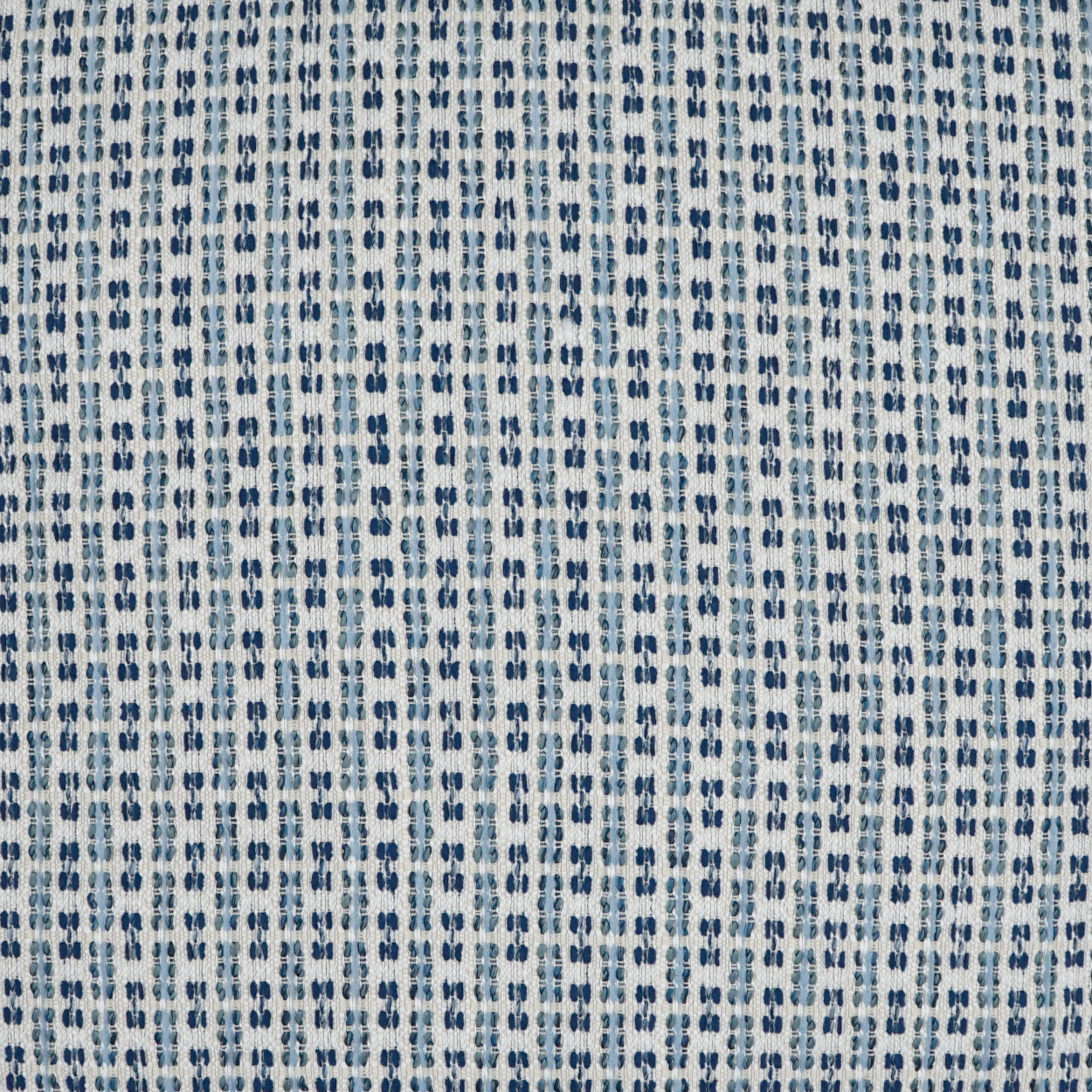 Light blue-gray outdoor pillow with woven fabric & repeating navy blue dotted vertical stripes.