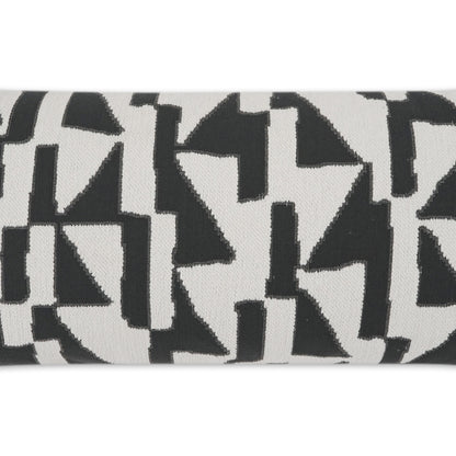 Close-up of black geometric triangles on white fabric, bold modern abstract textile pattern.