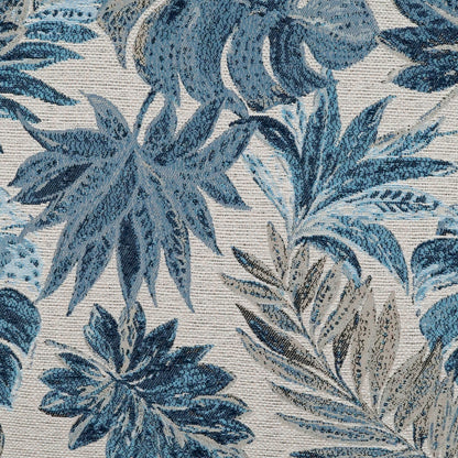 Blue tropical leaf print fabric with beige accents; woven botanical tapestry pattern.
