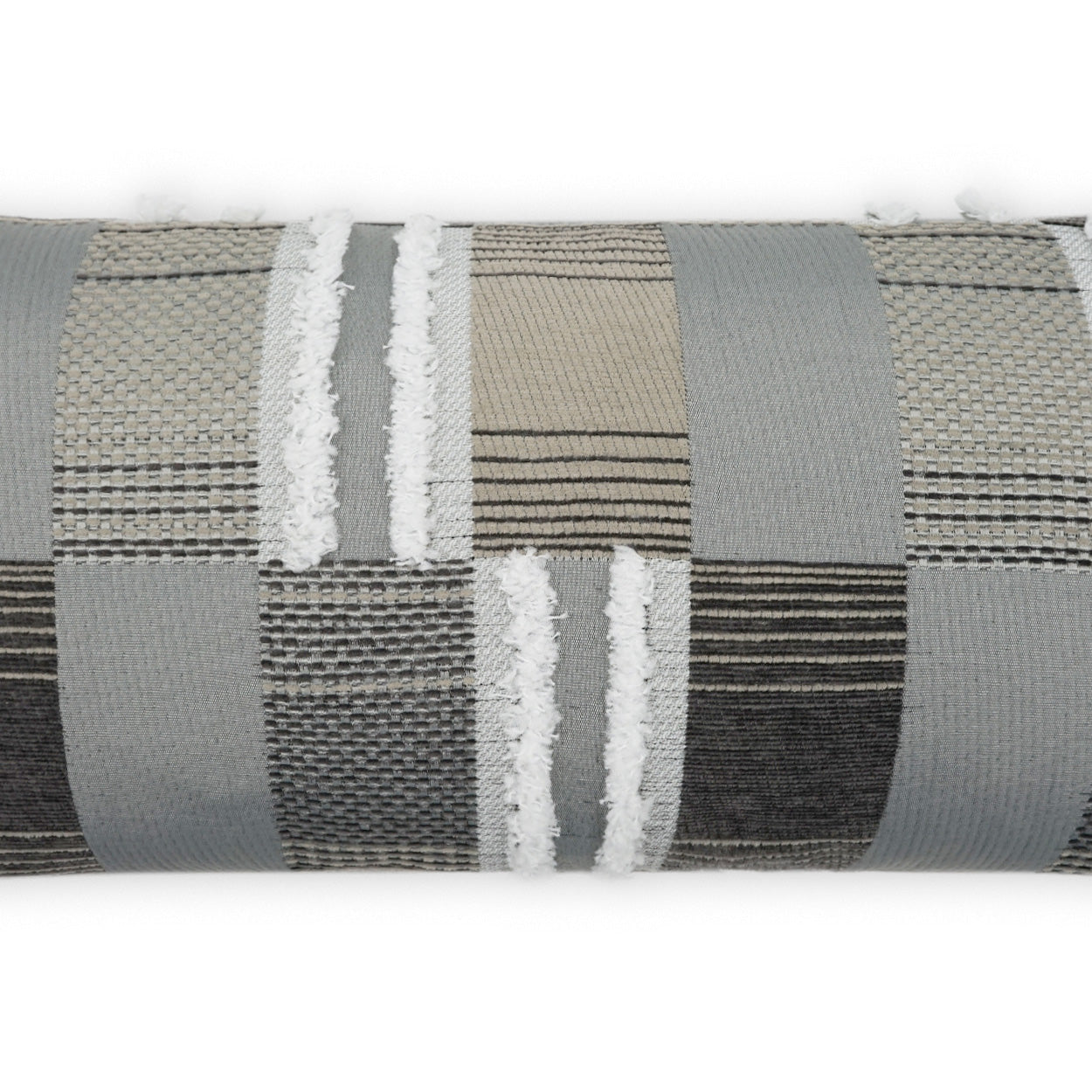 Patchwork upholstery fabric roll in gray, beige, and brown tones with woven stripes and white fringe.