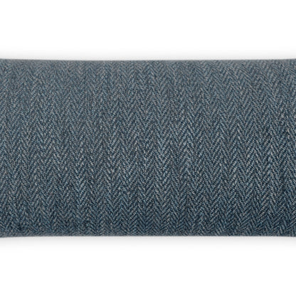 Blue denim herringbone tweed fabric with a textured zigzag weave, rolled into a cylinder.