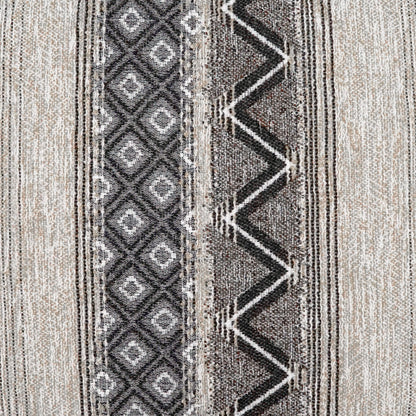 Beige and gray woven rug featuring a left diamond stripe and a right bold black zigzag band.