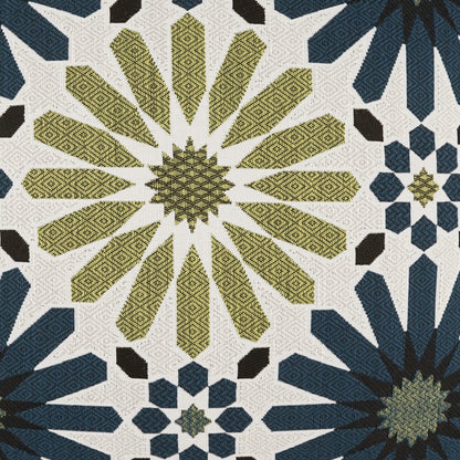 Geometric quilt woven fabric with olive-yellow starburst panels and navy blue star motifs on cream background.