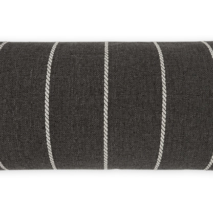 Charcoal grey woven upholstery fabric with white braided vertical stripes, rolled bolt.