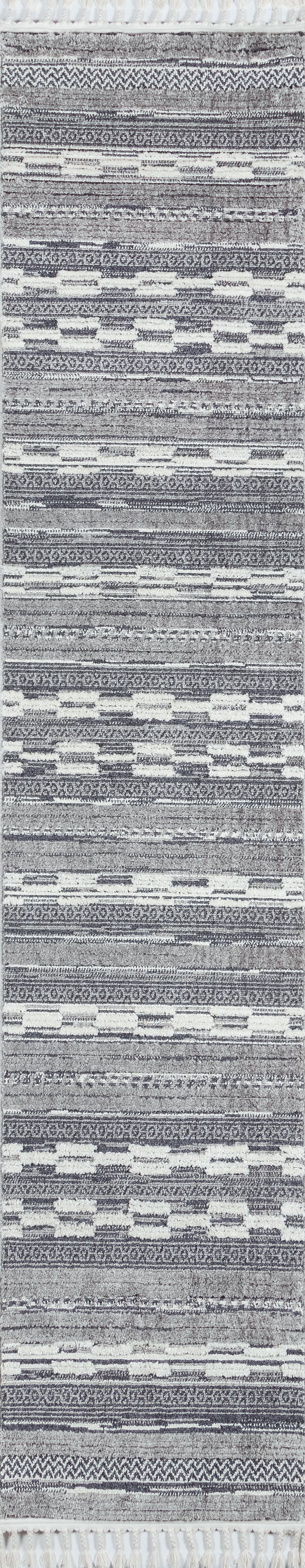 Long grey and white woven runner rug with geometric bands and white tassel fringe at ends.