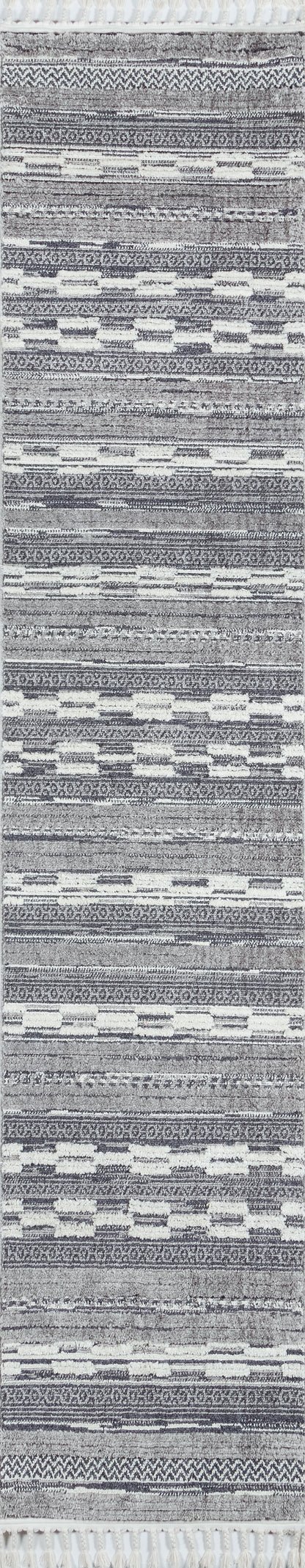 Long grey and white woven runner rug with geometric bands and white tassel fringe at ends.