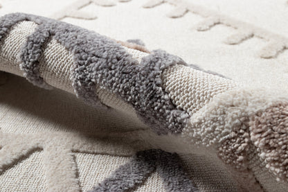 Neutral ivory and gray rug with plush boucle texture and rolled edge, cozy modern decor.
