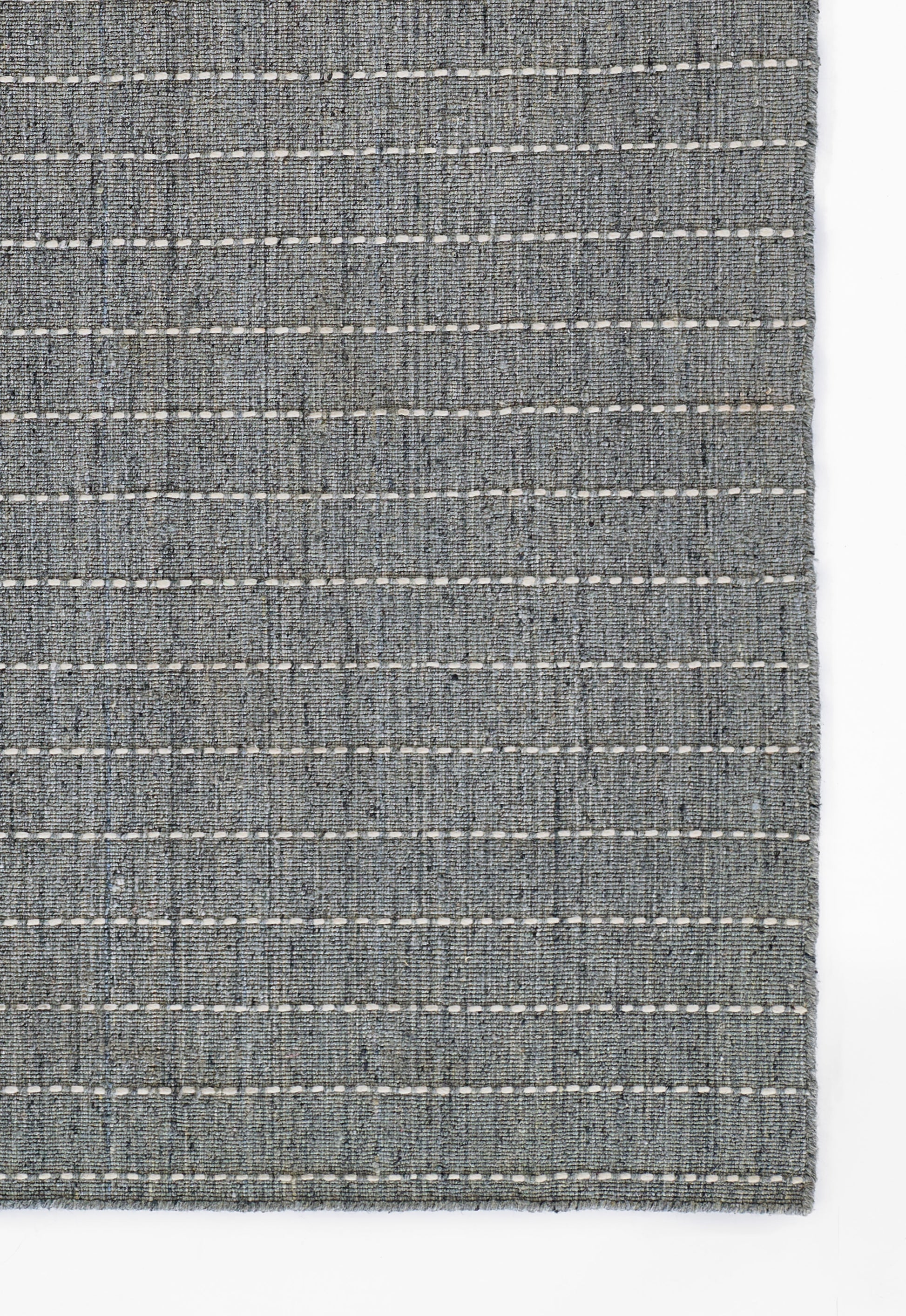 Blue-gray woven rug with white dashed stripes, rectangular and modern casual style.