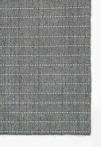 Blue-gray woven rug with white stitched horizontal stripes and textured fabric.