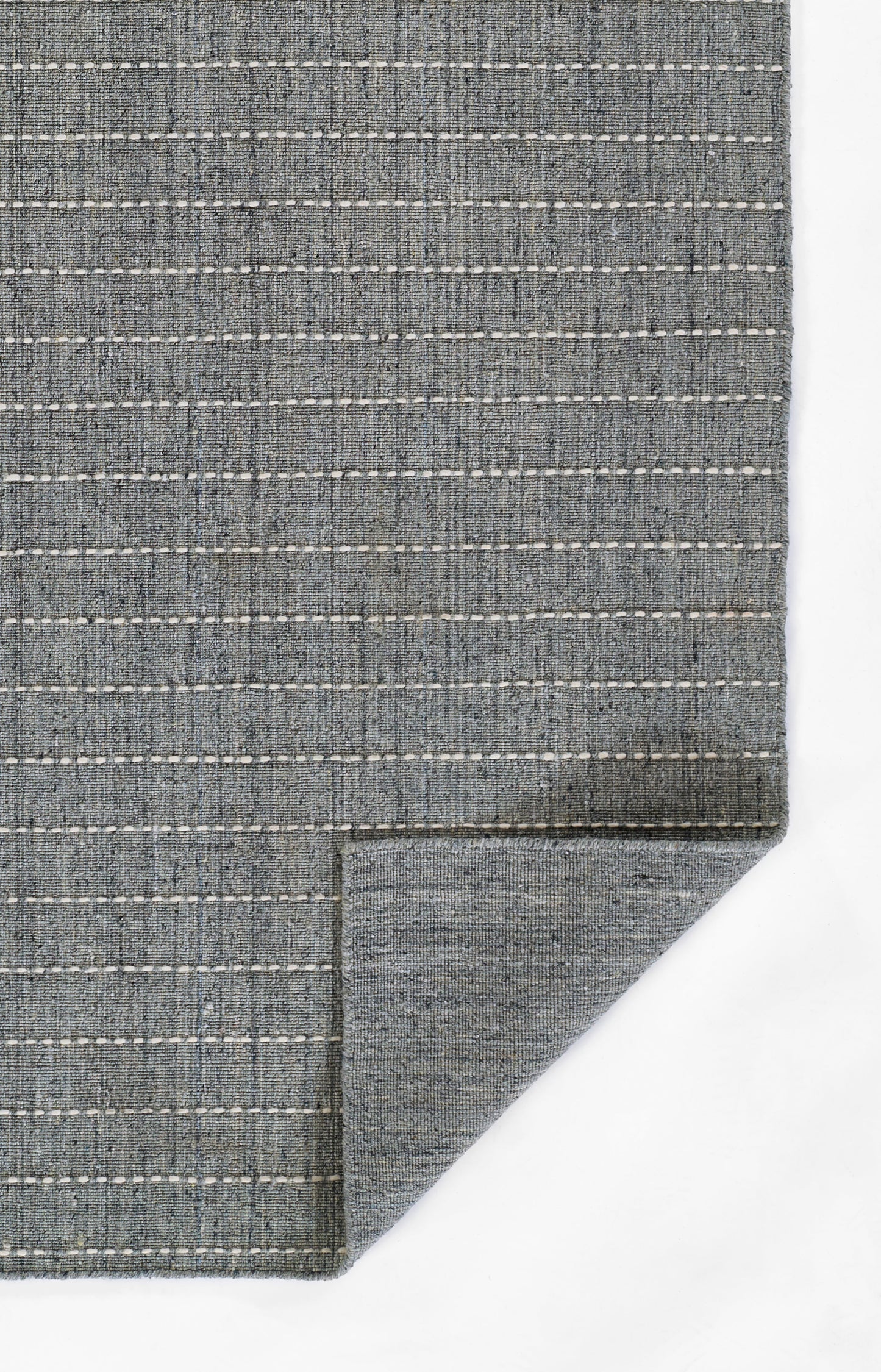 Blue-gray woven rug with white dashed stripes, flat-weave texture, rectangular.