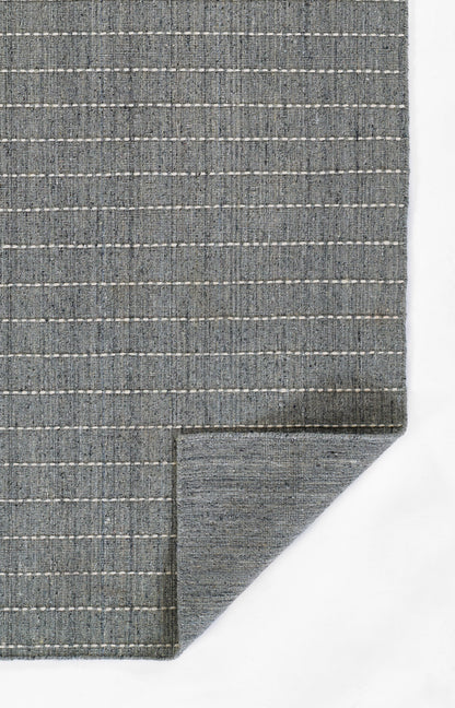 Blue-gray woven rug with white dashed stripes, flat-weave texture, rectangular.