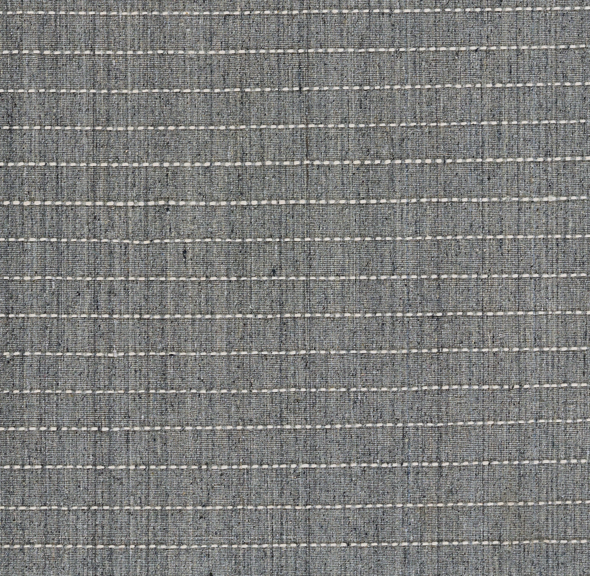 Blue-gray woven rug with horizontal white dashed stripes; denim-like texture.