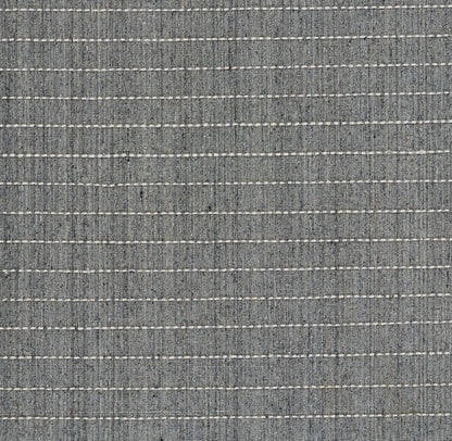 Blue-gray woven rug with horizontal white dashed stripes; denim-like texture.